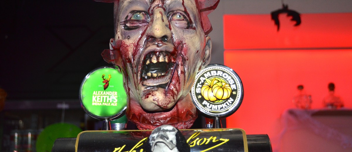 A bloody zombie-head dispenser on the bar.